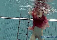 Katya Okuneva tempts in red dress by the pool