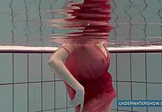 Katya Okuneva tempts in red dress by the pool