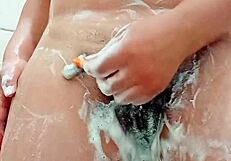 check out this young brunette shaving her hairy pussy up close in the bathroom mirror
