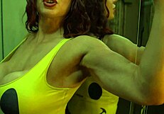 Muscular bodybuilder babe flexes bulging biceps in tight bikini for worship