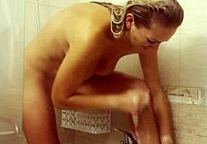 Milf masturbates shaved pussy in shower fingering big fake tits moaning