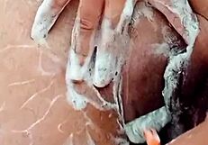 check out this young brunette shaving her hairy pussy up close in the bathroom mirror