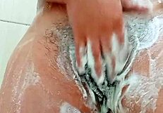 check out this young brunette shaving her hairy pussy up close in the bathroom mirror