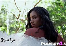 Black milf bares big natural tits and curvy ass outdoors