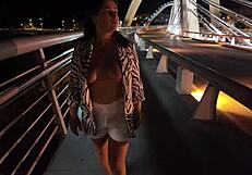 Luscious milf walks without a bra and panties on the bridge