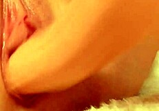 She uses the dildo to penetrate her creamy pussy