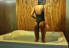 Petite brunette teases in jacuzzi