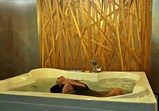 Petite brunette teases in jacuzzi