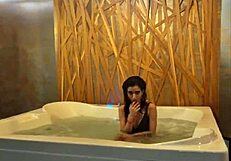 Petite brunette teases in jacuzzi