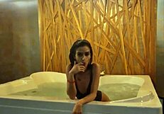 Petite brunette teases in jacuzzi