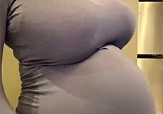 the pregnant stepmother pulls her milky tits out of her red bra