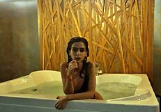 Petite brunette teases in jacuzzi
