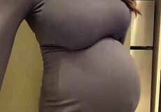 the pregnant stepmother pulls her milky tits out of her red bra
