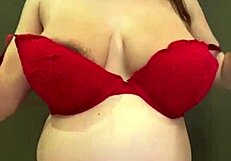 the pregnant stepmother pulls her milky tits out of her red bra