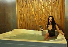 Petite brunette teases in jacuzzi