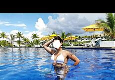 curvy brazilian relaxes poolside wearing tiny bikini