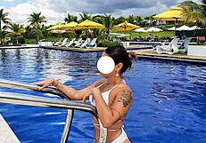 curvy brazilian relaxes poolside wearing tiny bikini
