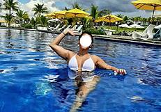 curvy brazilian relaxes poolside wearing tiny bikini