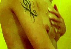 brunette with tattoos has a nice shower
