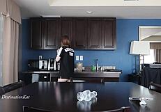 Redhead teases with dildo on table